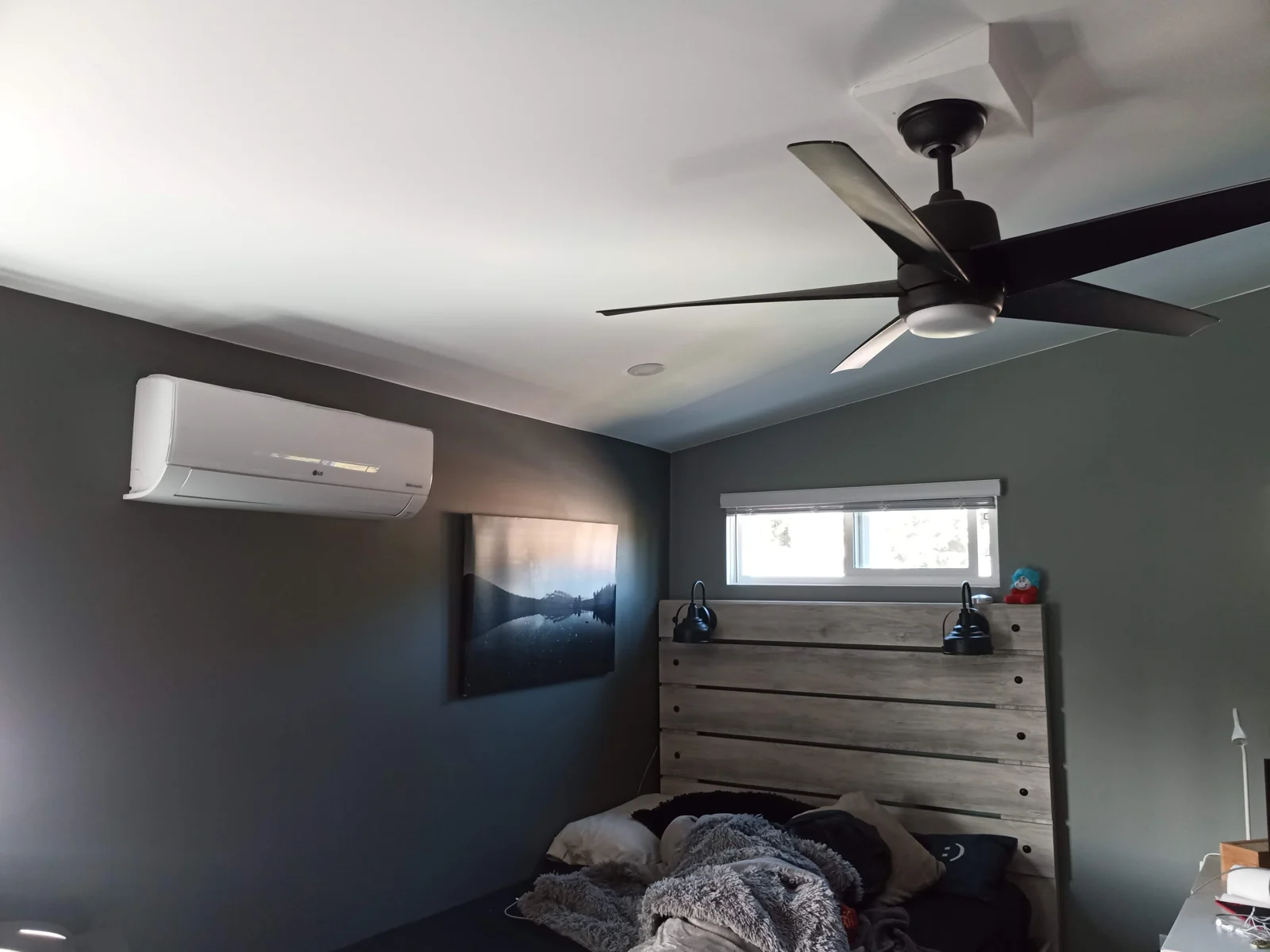 A wall-mounted ductless unit installed in a residential bedroom